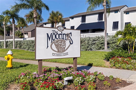 Front view of a residential building with a sign that reads 'The Moorings of Tierra Verde'.