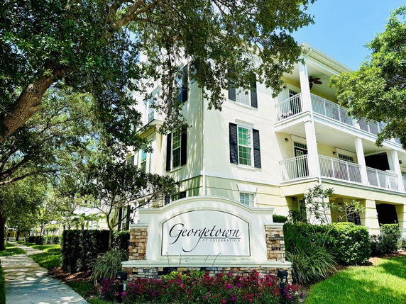 Front view of a multi-story building with multiple balconies and a sign that reads 'Georgetown at Celebration.'