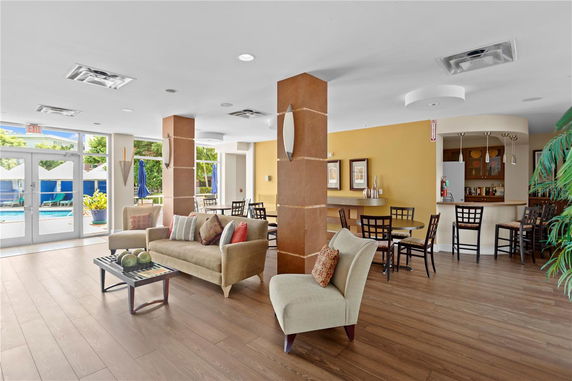 Interior view of a clubhouse with seating area and tables.