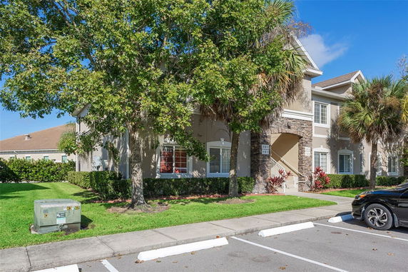 Front view of a multi-story residential building with stone accents.