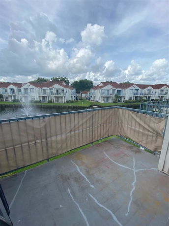Panoramic view showing multiple residential buildings with red roofs adjacent to a water body.