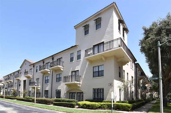 Front view of a multi-story apartment building with balconies.