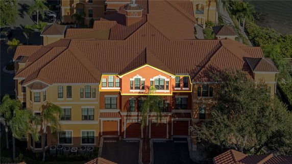 Front view of a multi-story building with orange exterior and multiple windows.