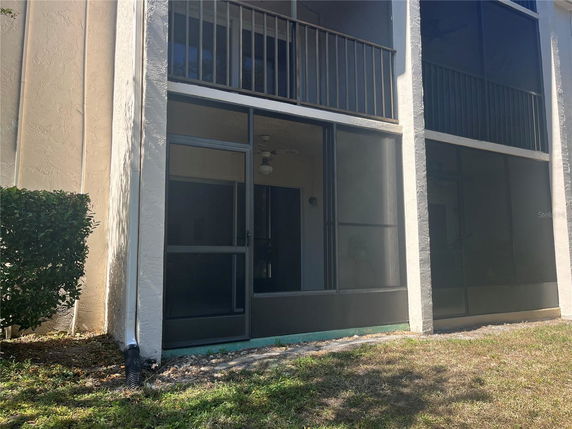 Front view of a multi-story building with screened balconies.
