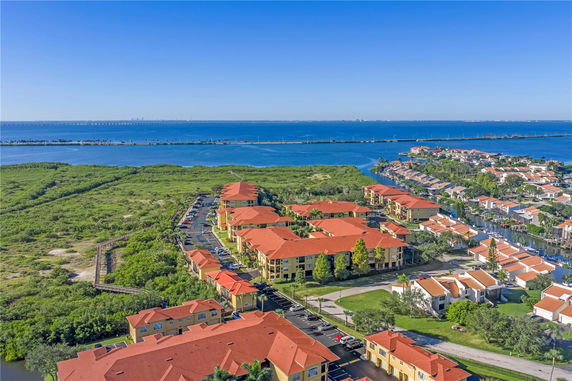 Panoramic view of a coastal residential area with multiple buildings and a water body nearby.