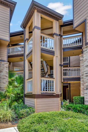 Front view of a multi-story building featuring exposed staircases and railings.