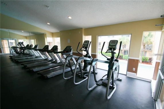 Interior view of a gym with treadmills and exercise machines.