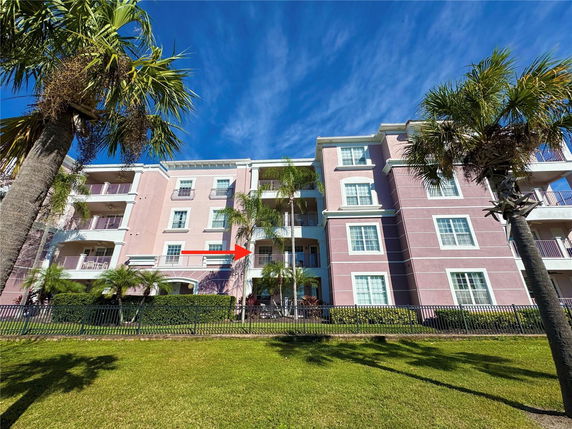 Front view of a multi-story apartment building with balconies.