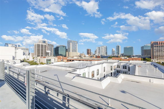 Panoramic view of city skyline from a rooftop.