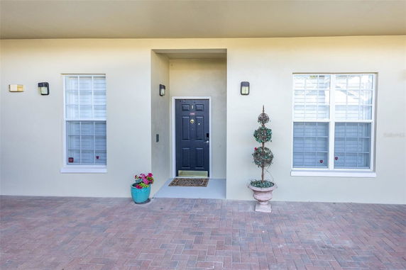 Front view of a house with a centered door and two windows.