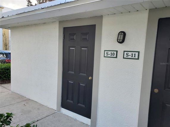 Front view of a small, single-story storage structure with numbered doors S-10 and S-11.