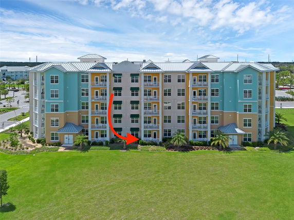 Front view of a multistory apartment building with colorful exteriors and balconies.