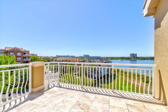 Rooftop view of surrounding buildings and water body.