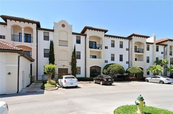 Front view of a three-story apartment building with balconies.