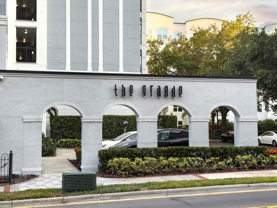 Front view of a multi-story building with arched entrances labeled 'the grande'.