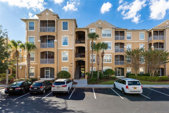Front view of a multi-story residential building with balconies.