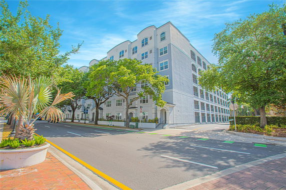 Front view of a multi-story residential building with white exterior.