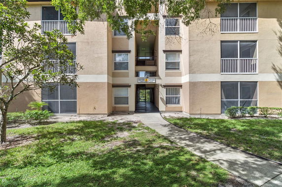 Front view of a multi-story apartment building with balconies.