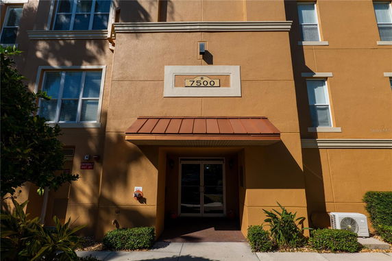 Front view of a multi-story building entrance with a canopy.