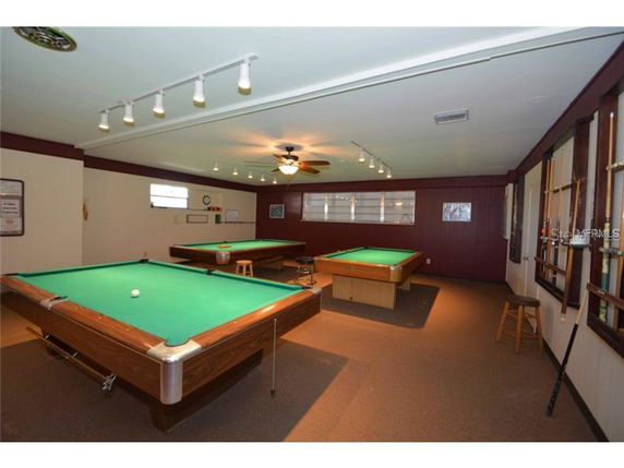 Interior view with billiards tables and seating area.