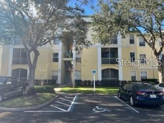 Front view of a multi-story residential building with parking area.