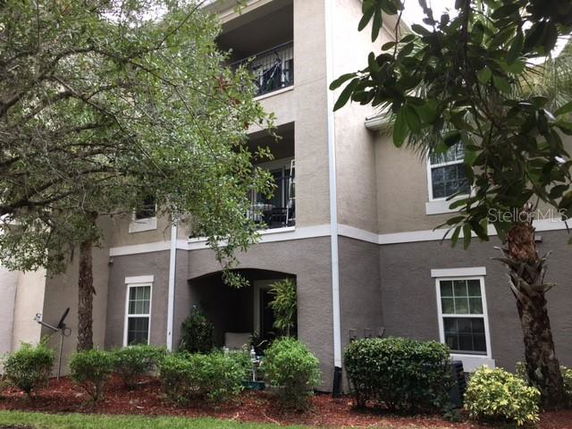Front view of a multi-story residential building with balconies and windows.