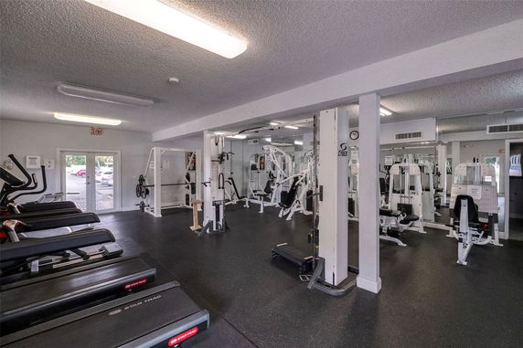Interior of a gym with exercise machines and equipment.
