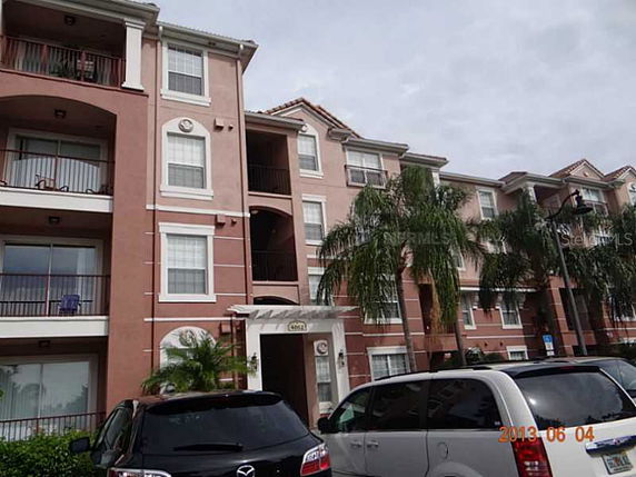 Front view of a multi-story apartment building with balconies.