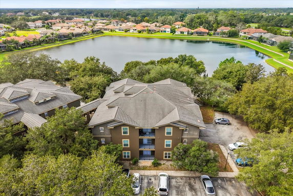 Aerial view of residential buildings near a large pond.