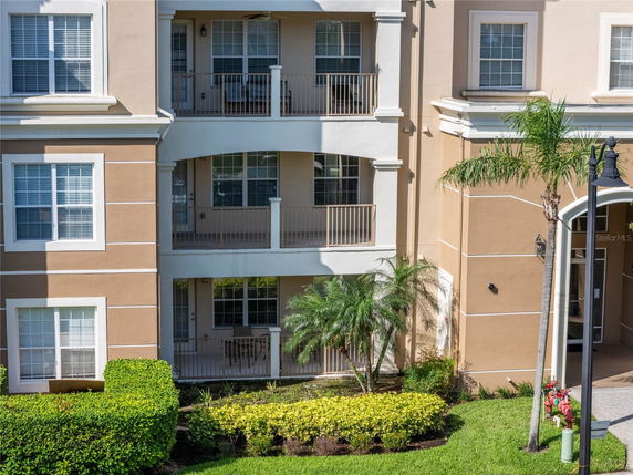 Front view of a multi-story residential building with balconies and windows.