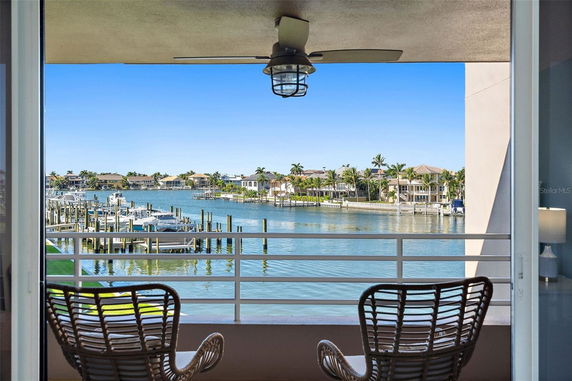 View of a waterfront area with houses and docks seen from a balcony.