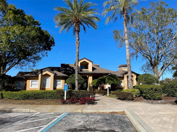 Front view of a single-story house with a unique roof design and prominent entryway.