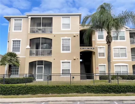 Front view of a multi-story residential building with balconies.