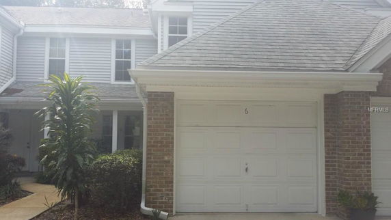 Front view of a two-story house with a single garage.