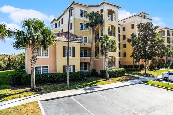 Front view of a multi-story residential building with balconies.