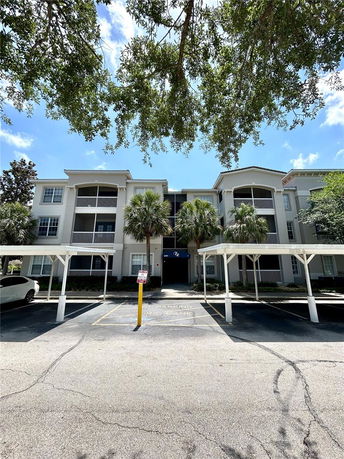 Front view of a three-story apartment building with balconies.