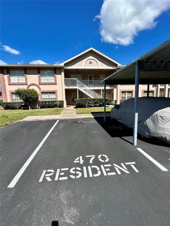 Front view of a two-story residential building with exterior staircase.