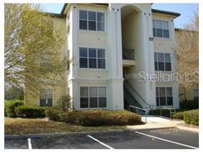 Front view of a multi-story residential building with exterior stairs.