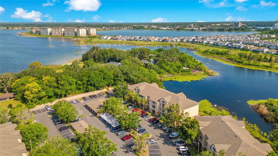 Panoramic view of a lakeside area with residential buildings and water bodies.