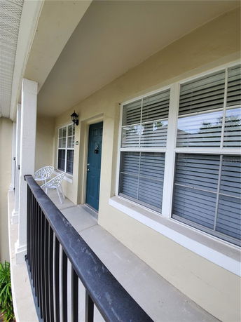 Front view of a house with a porch and green door.