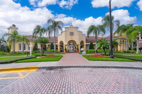 Front view of a grand, single-story building with an arched entrance and decorative windows.