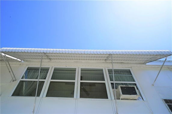 Front view of a building with windows and an awning.