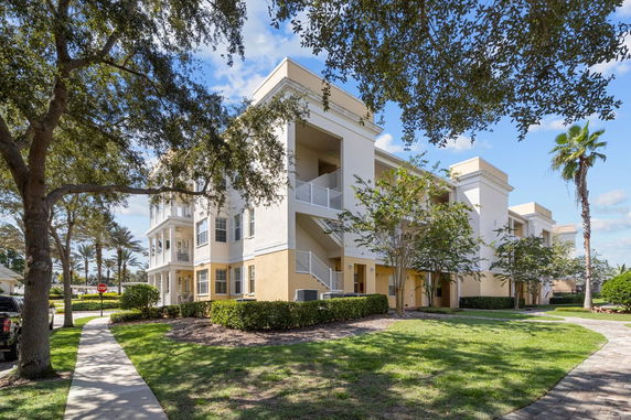 Front view of a multi-story apartment building with balconies.
