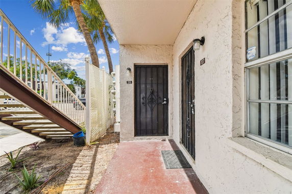Entrance view of an apartment building with two doors numbered 106 and 107.