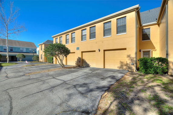Front view of a two-story building with double garage doors.
