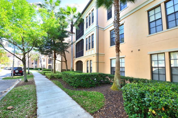 Front view of a multi-story building with beige exterior and multiple windows.