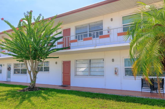Front view of a two-story building with balconies.