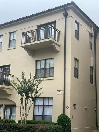 Front view of a multi-story building with balconies.