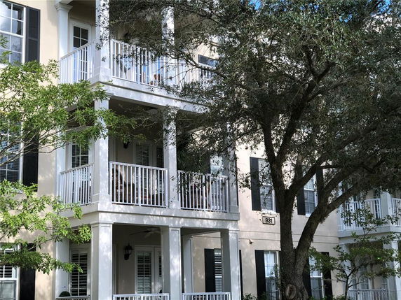 Front view of a multi-story building with balconies.