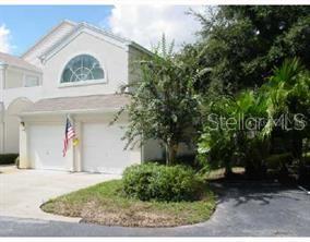 Front view of a house with a double garage and an American flag.